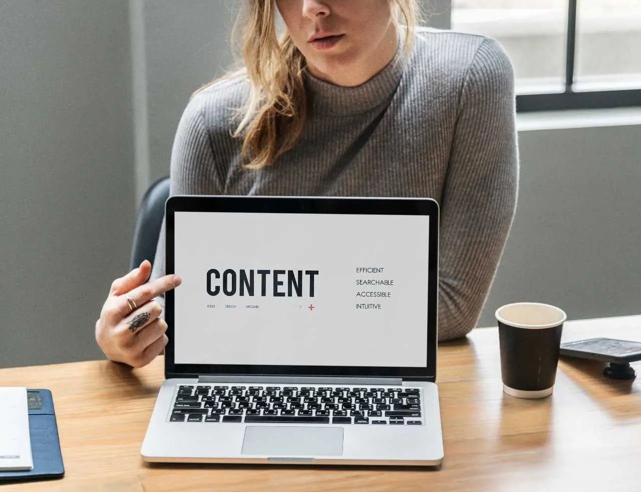 woman point to content on laptop