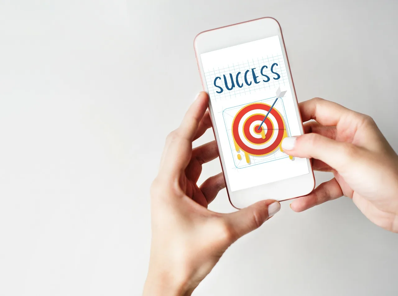 hands on smartphone showing a campaign success