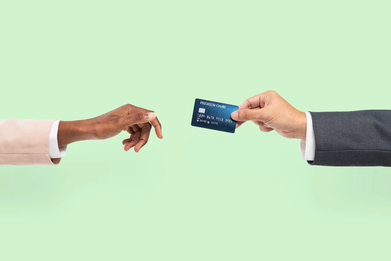 credit card handed to a marketing manager